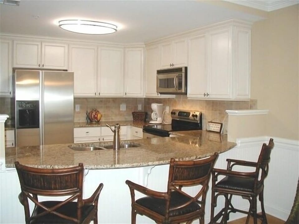 Fully equipped kitchen with stainless steel appliances and  granite counter tops