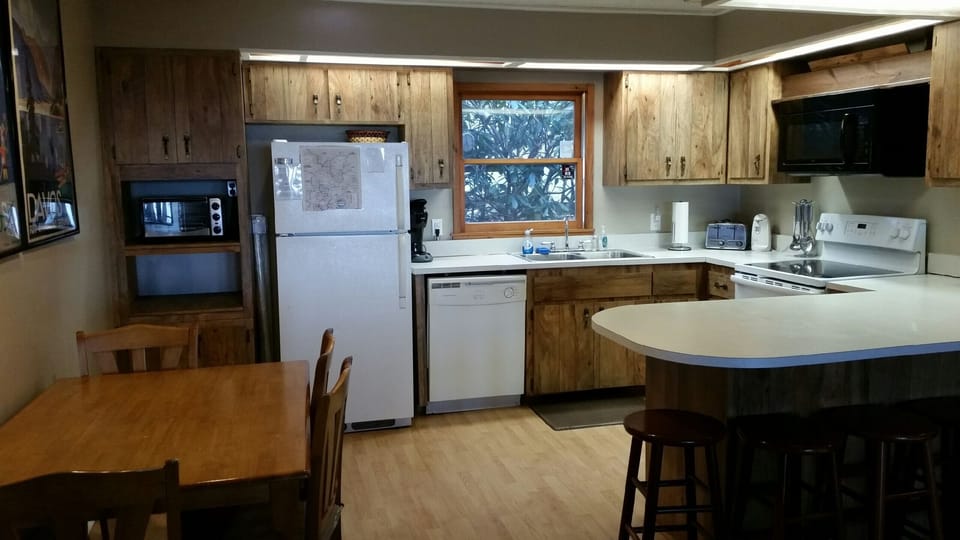 full kitchen, seats ten, there are 4 chairs with table, and 6 stools at counter