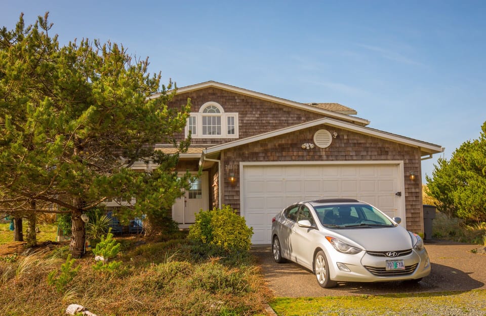 Front of home from driveway, gas barbeque and 4 mtn bikes for your use in garage