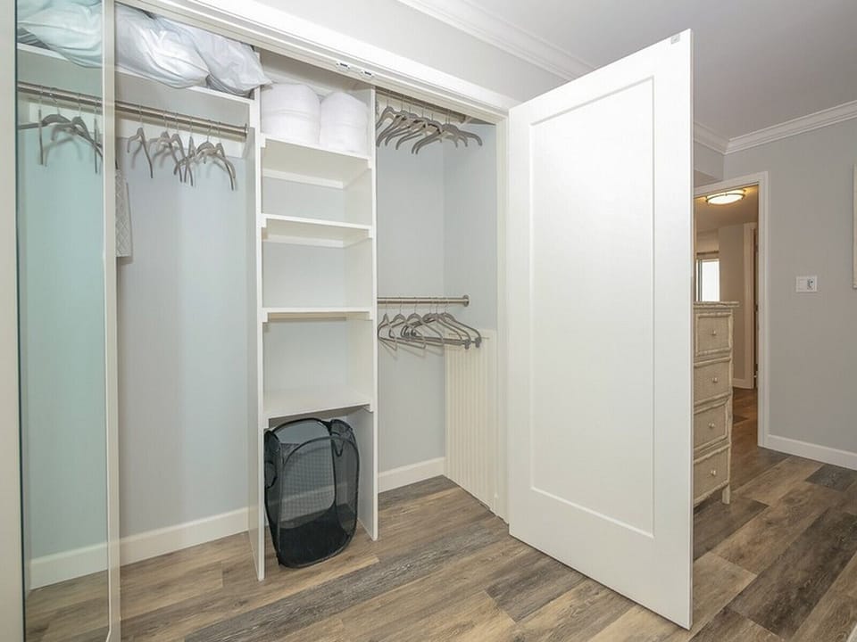 Guest Bedroom Closet with Floor Length Mirror and Plenty of Storage Space at 2403 Island Club