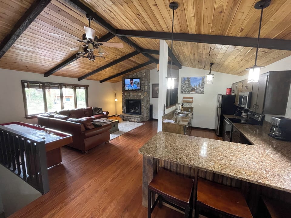 kitchen and family room - shuffleboard table behind the couch