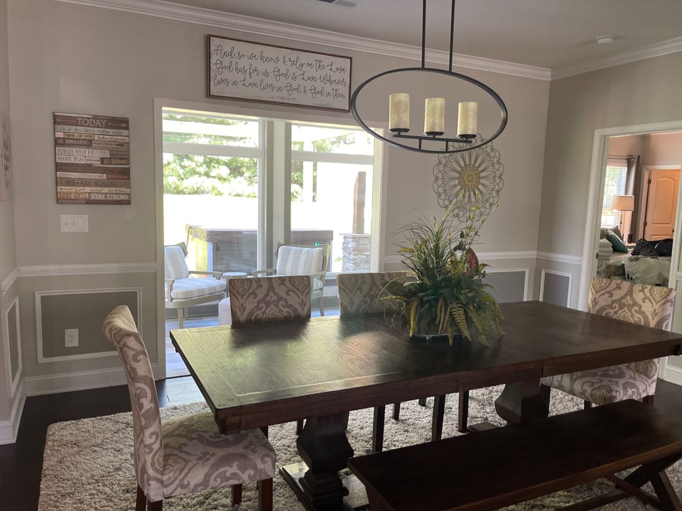 Dining room comfortably sits 8 looking into sunroom