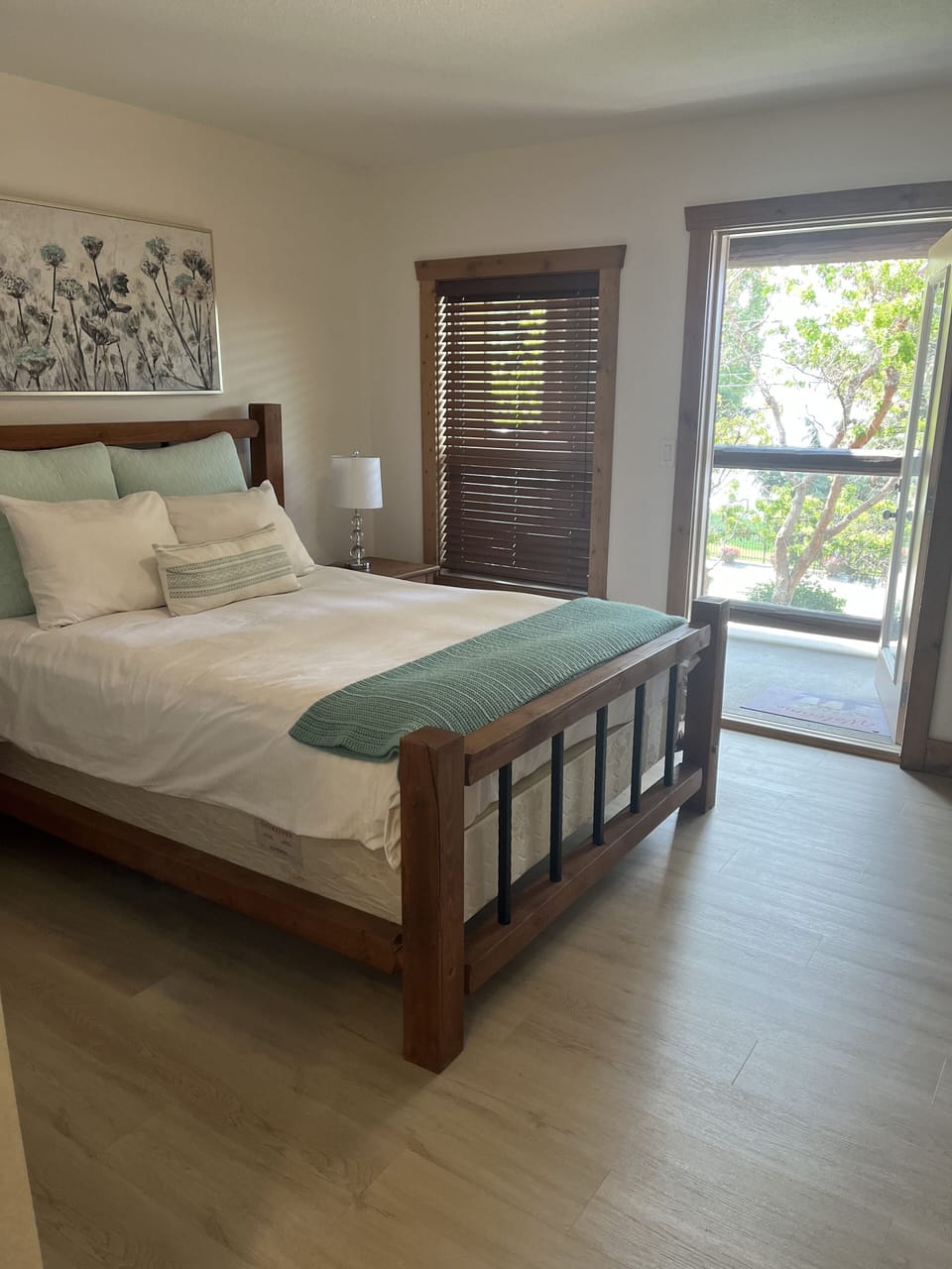 Master bedroom with balcony that looks out over the lake