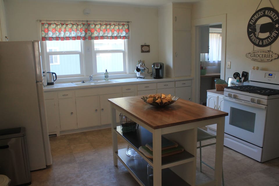 Kitchen with Keurig coffee maker, kettle, microwave, oven, pots, pans, etc! 