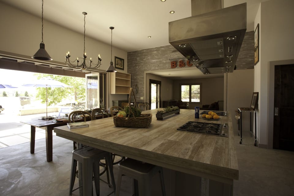 Looking out the bi-fold doors to the patio and pasture; seating alcove on right