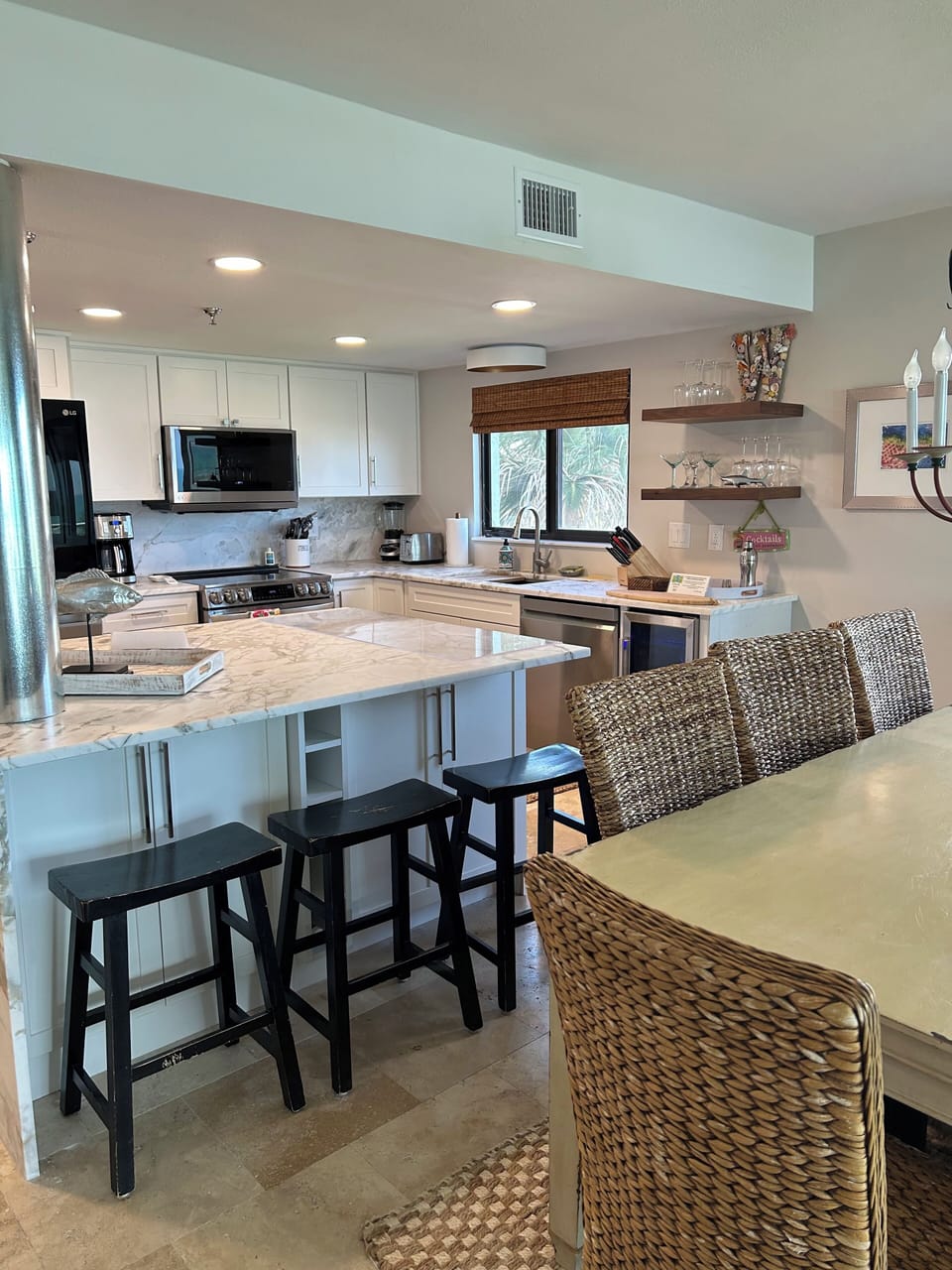 Kitchen island view with game storage below & additional stool seating.