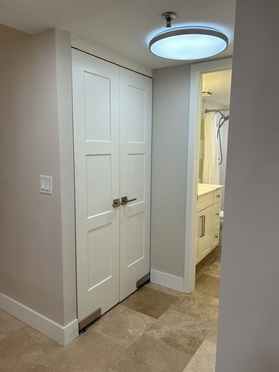 Laundry closet adjacent to kitchen island.