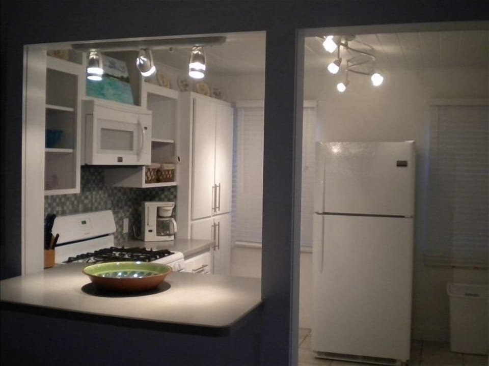 Corian kitchen and bar area at night .
Lighting can be dimmed for entertainment 