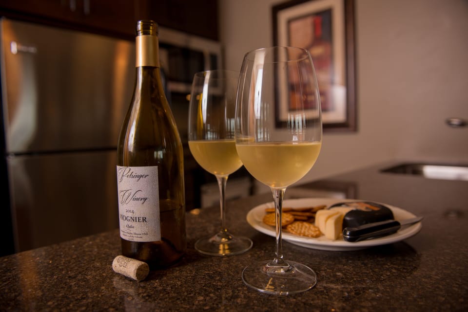 Wine and cheese go great with sunsets and soft music from the smart TV.