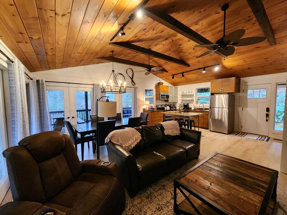 The living room features brand new floors, wood ceilings and whitewashed walls.