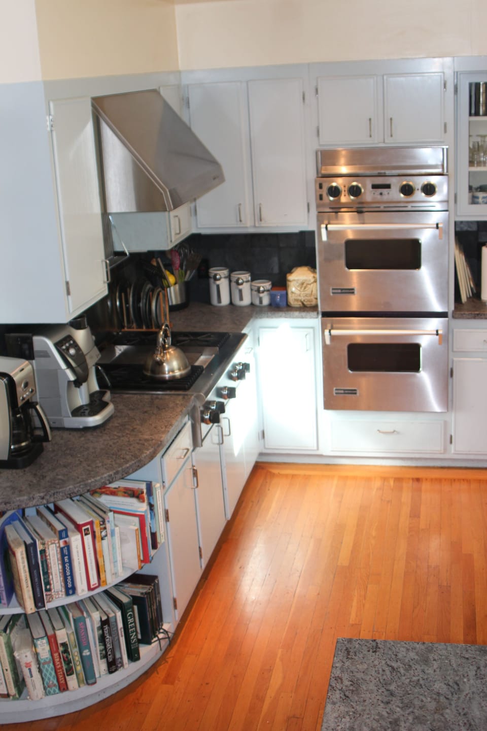 Kitchen features 4-burner range with griddle, Venmar hood, Jenn-Air double oven