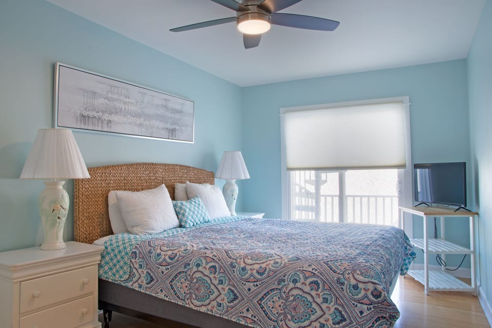 On the left of hallway. King with stand up shower. Balcony to roof deck.