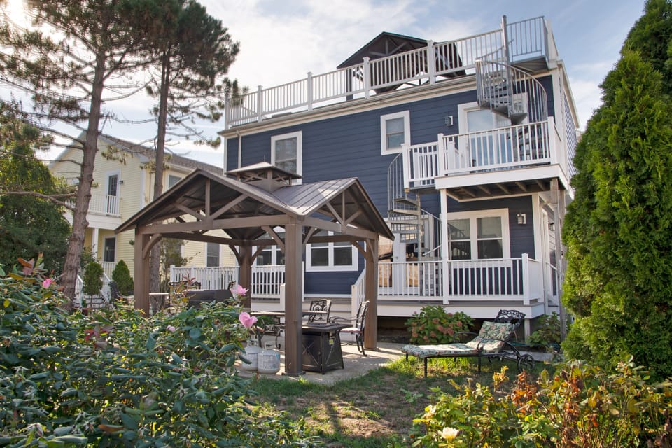 Backyard with private dining/seating area under gazebo.