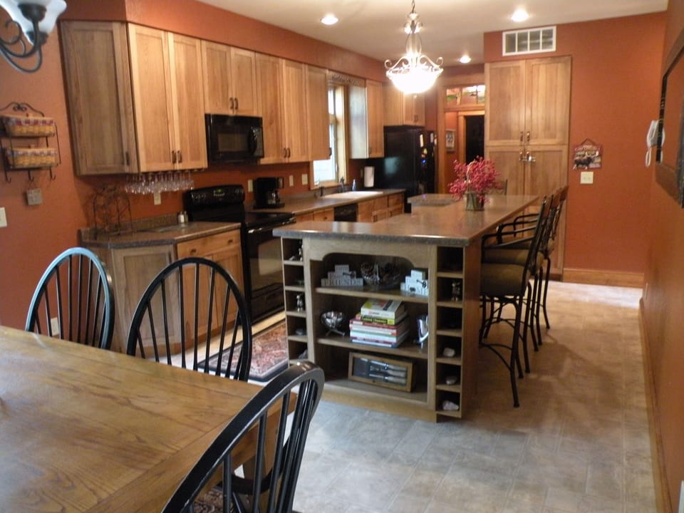 Kitchen with a bi-level bar that seats 4, lots of spices, coffee/sugar/cream