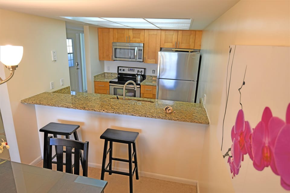 Updated kitchen with granite countertops and stainless steel appliances. 
