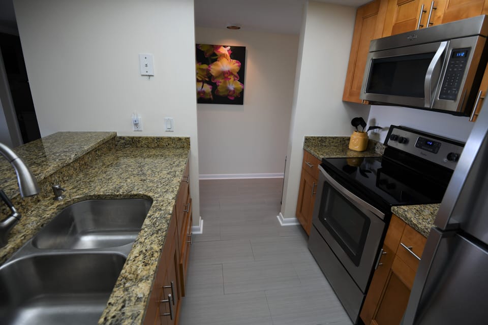 Updated kitchen with granite countertops and stainless steel appliances. 