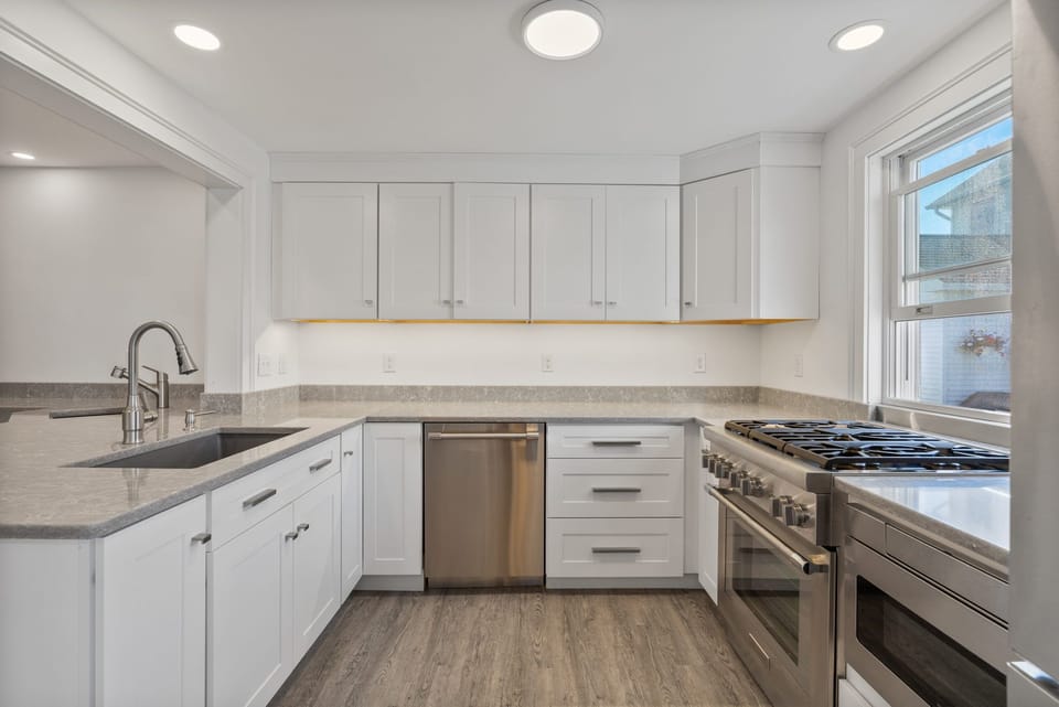 stainless steel large kitchen with plenty of light and areas for cooking/prep
