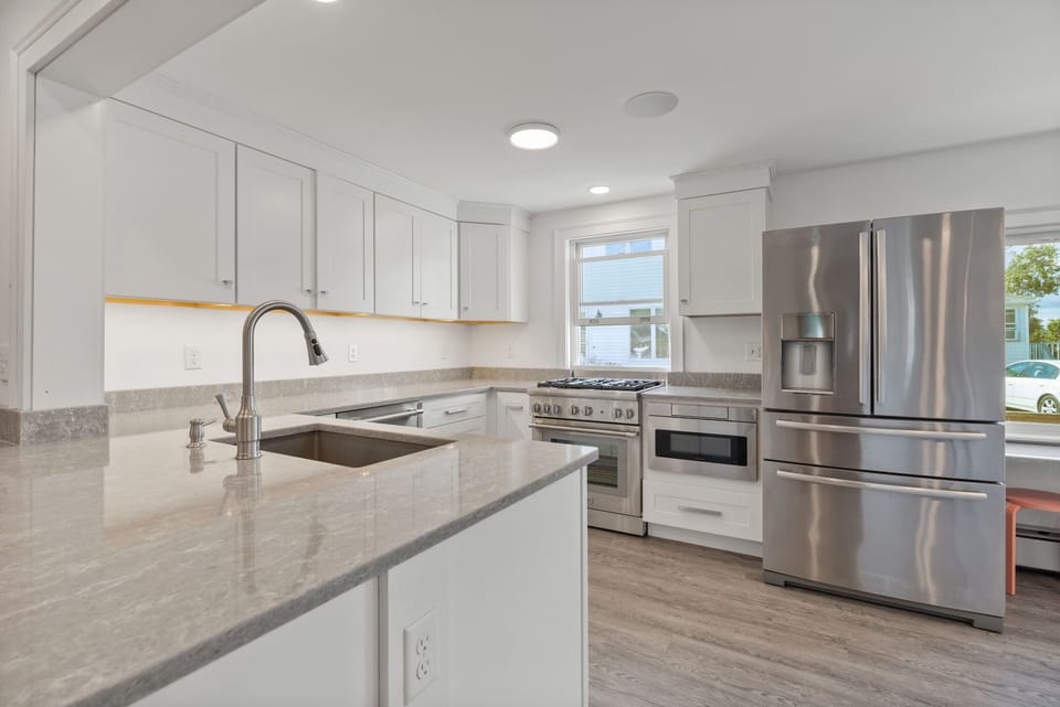 upgraded appliances, stainless steel, stocked kitchen-pots, pans, utensils, etc.