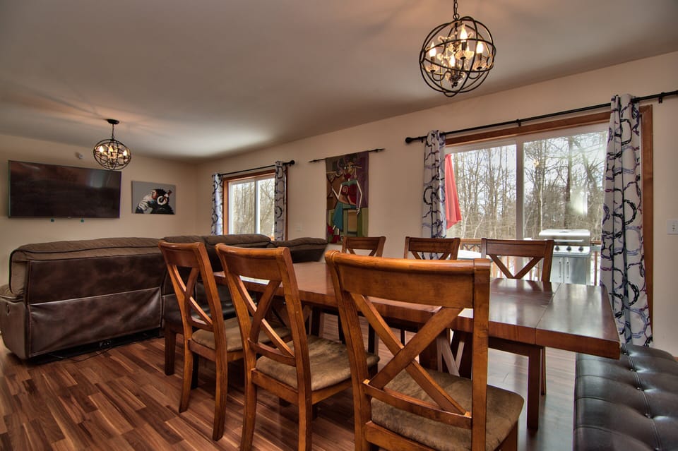 Large dining table with porch access with BBQ grill pictured