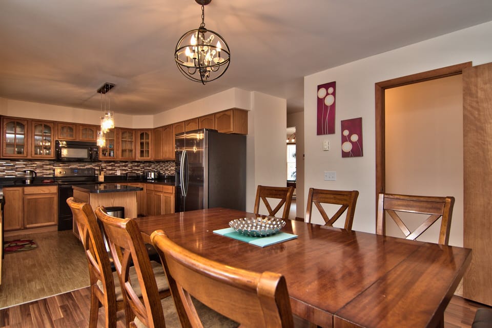 Large dining table with seats for 6 and 2 benches to accommodate 10+ people 