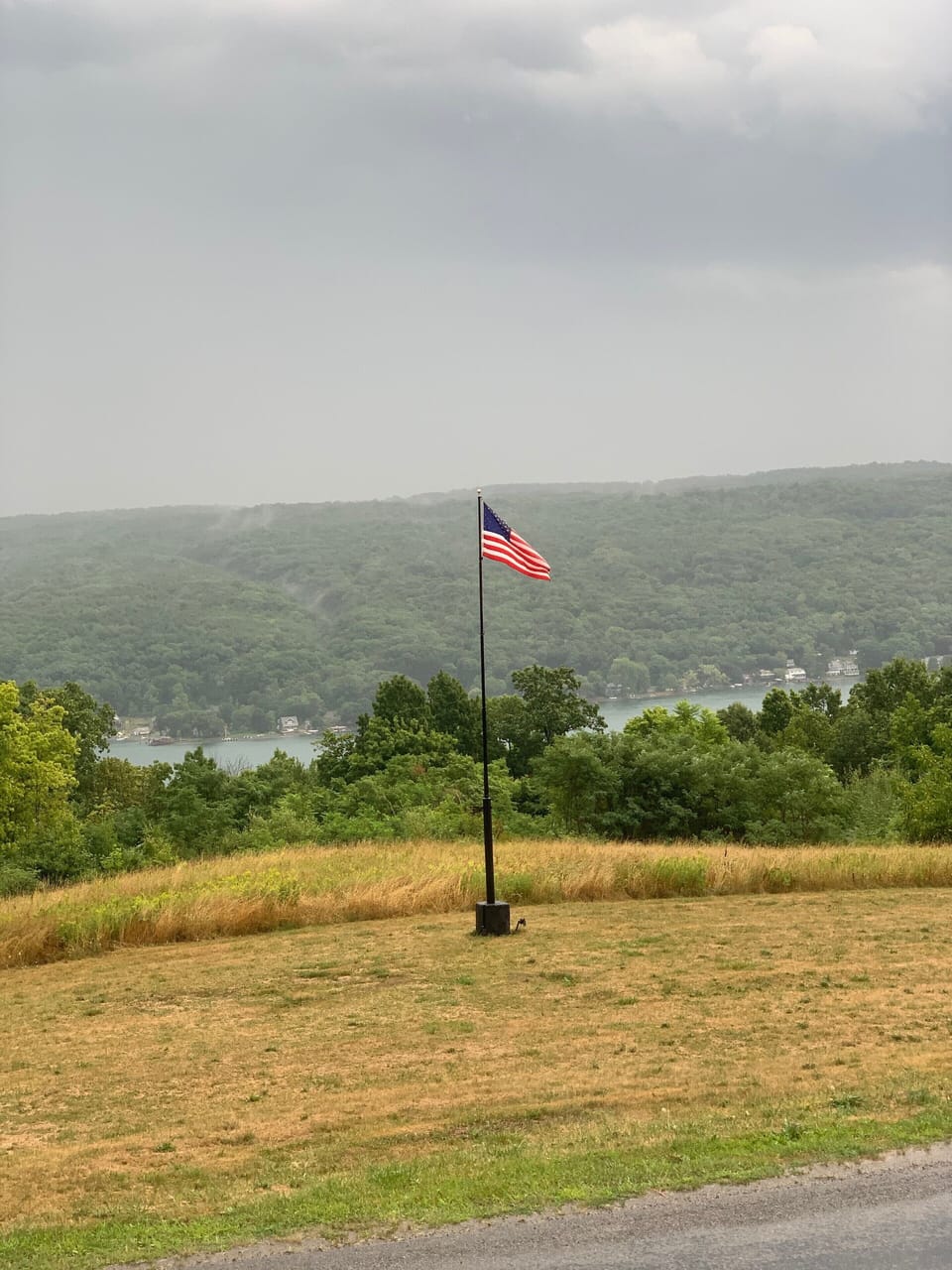 Our flag swaying in the breeze as a summer storm rolls over the lake!