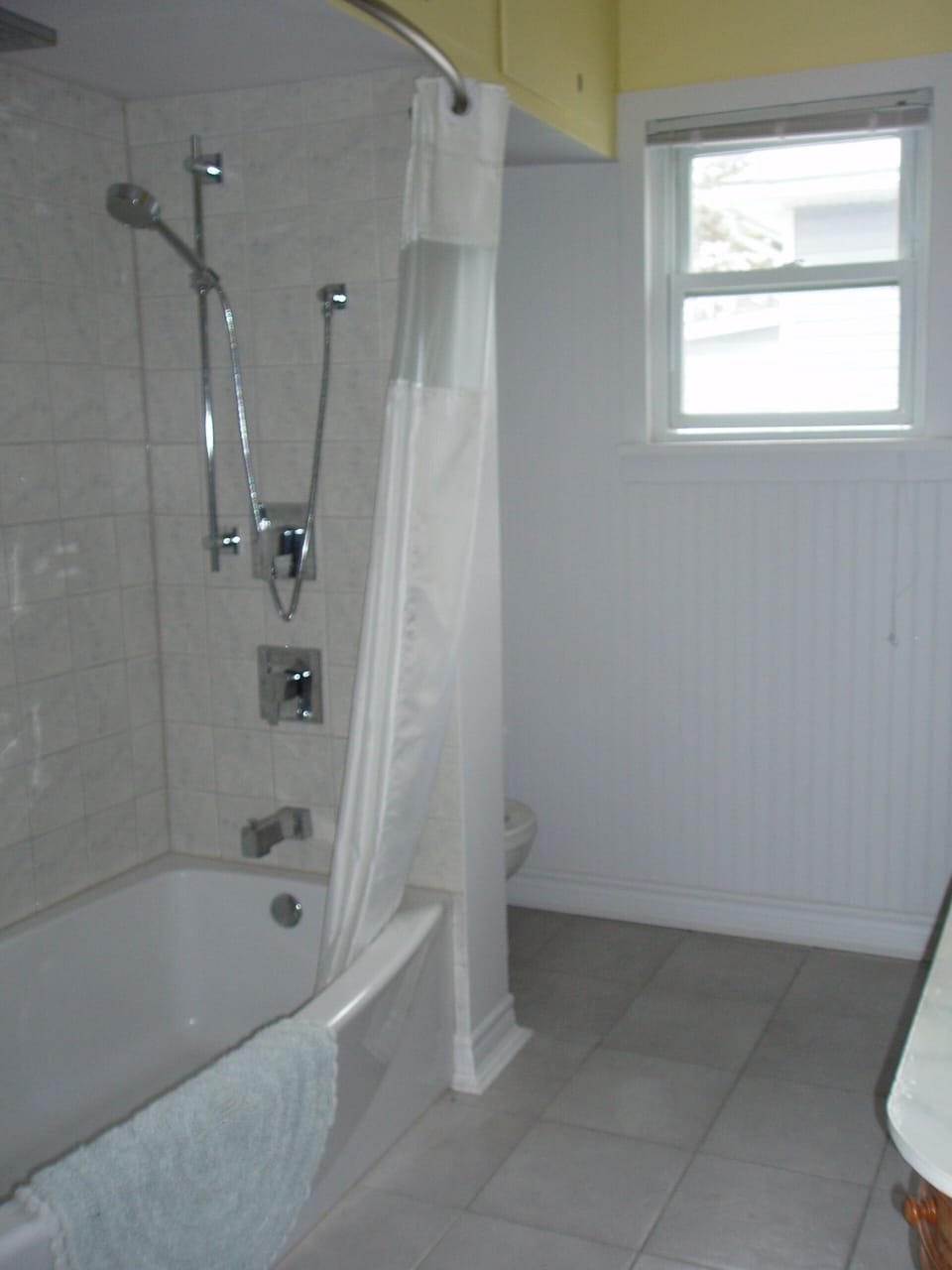 Enjoy a relaxing rain shower or a hot bath in the large, curved tub.