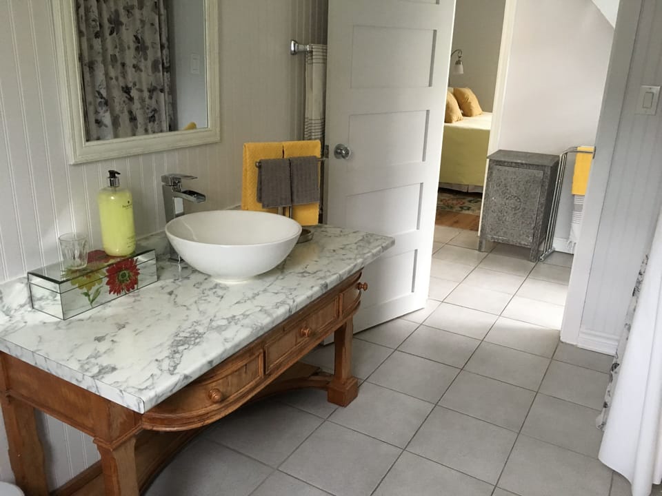 Pretty wainscoting and fixtures, a basin sink and... your toothbrush.