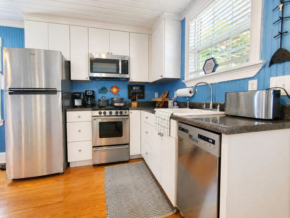 Stocked kitchen with refrigerator, dishwasher, gas stove and more
