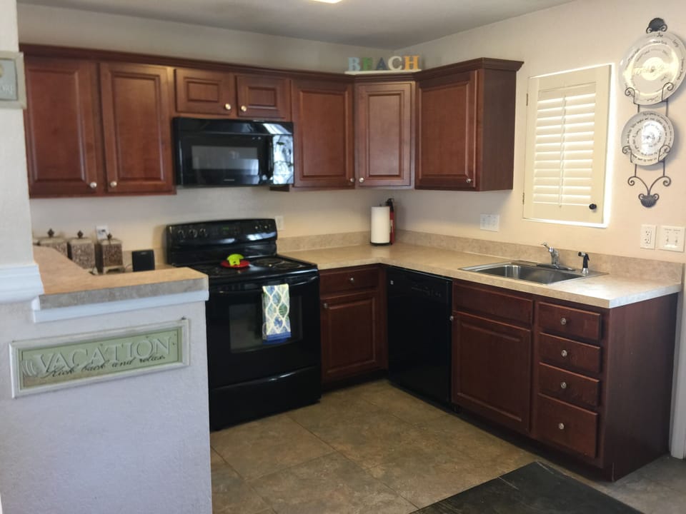 Full kitchen with above stove microwave, dishwasher and refrigerator. 