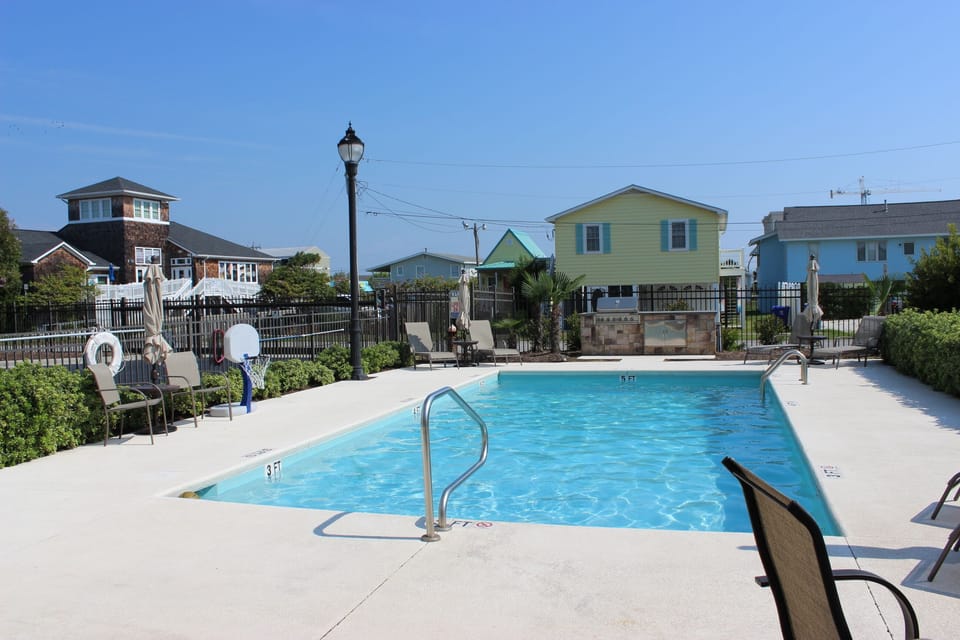 Swimming pool with outdoor grilling area.
