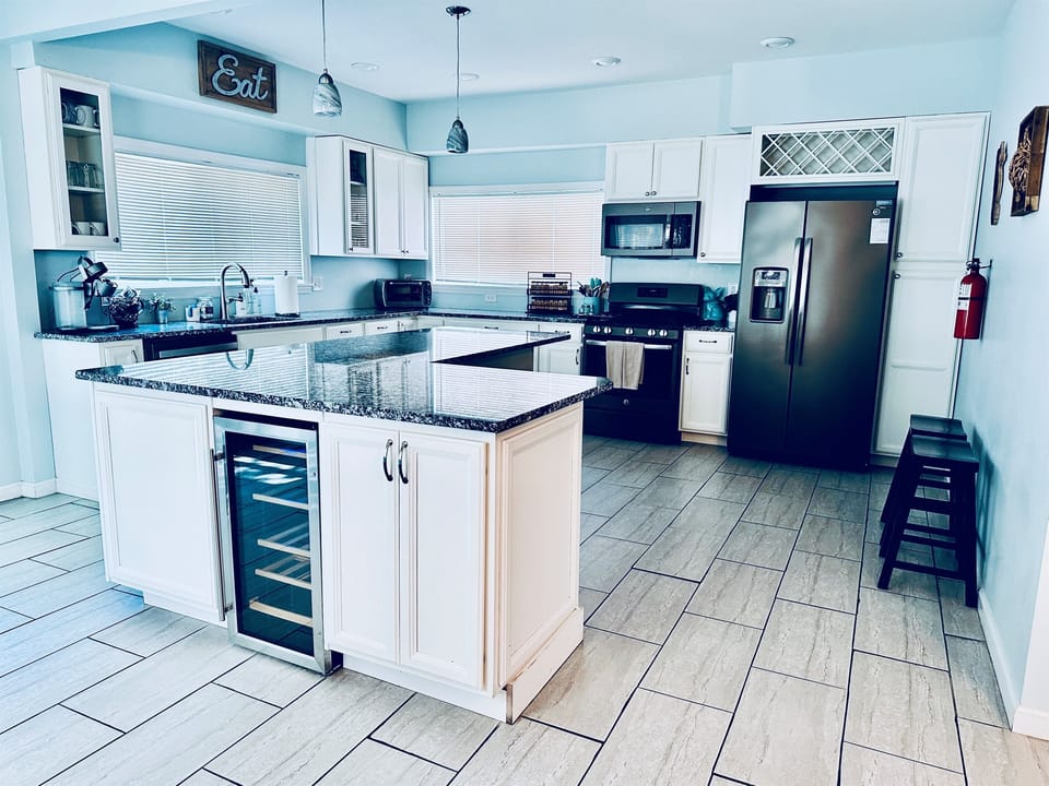 Fully Stocked Kitchen | Main Floor | Open Concept | Granite Countertops | Stainless Steel Appliances | Wine Fridge | Large Island with Seating for 4