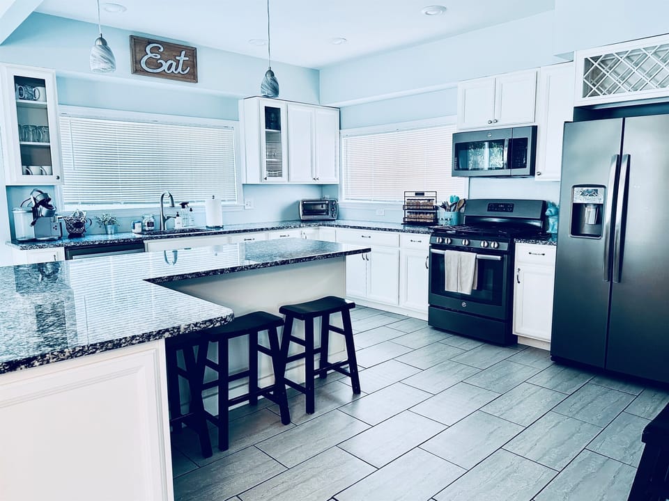Fully Stocked Kitchen | Main Floor | Open Concept | Granite Countertops | Stainless Steel Appliances | Wine Fridge | Large Island with Seating for 4