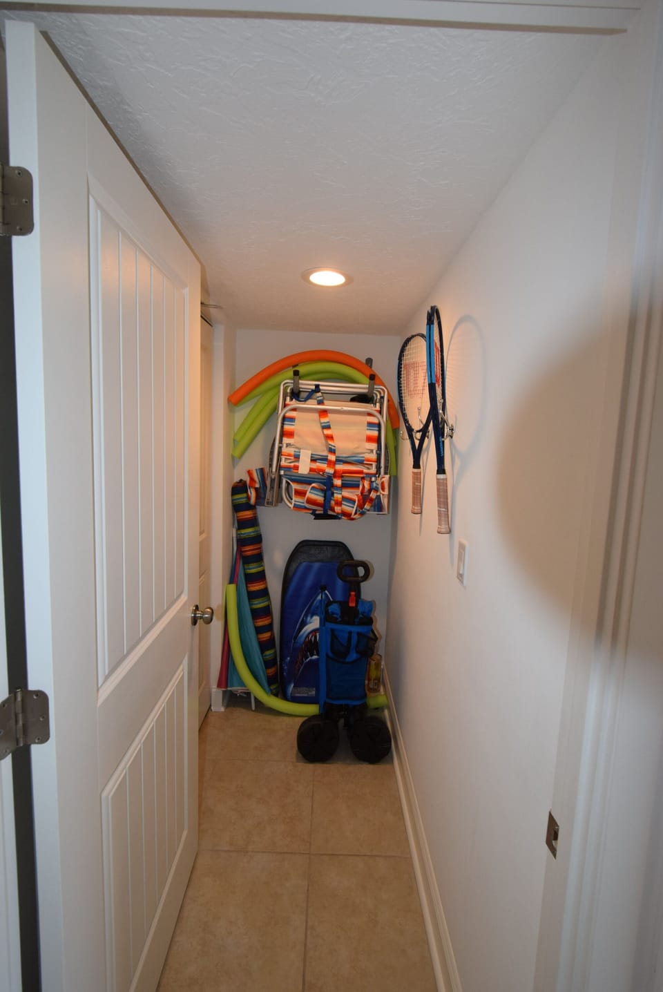 Storage area, beach, chairs, umbrellas, tennis rackets
