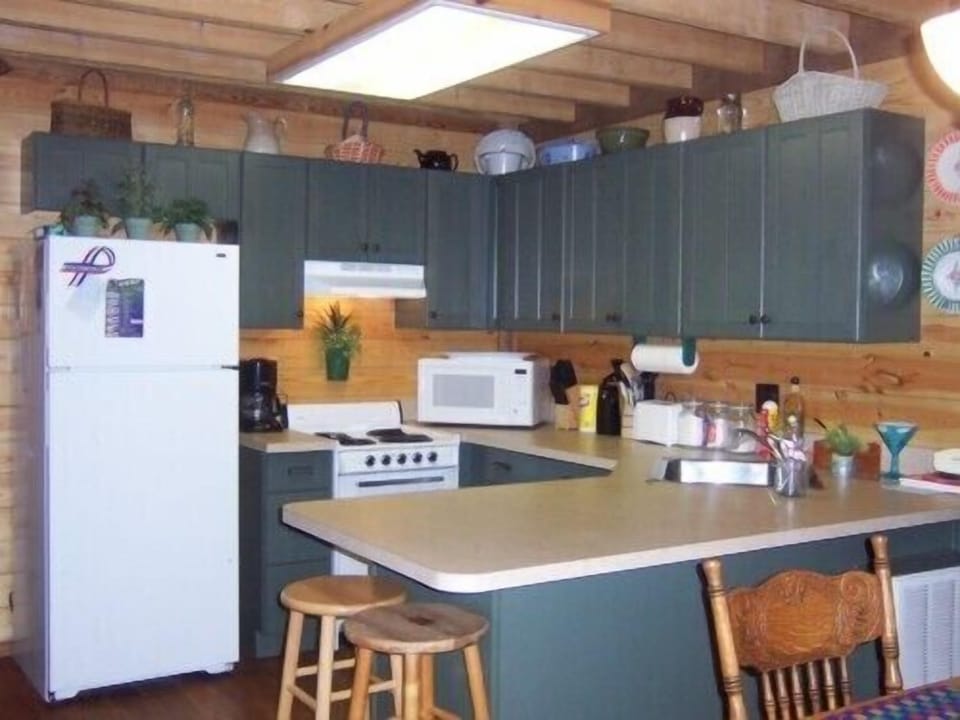 efficient kitchen, fully stocked with cooking utensils and serving dishes