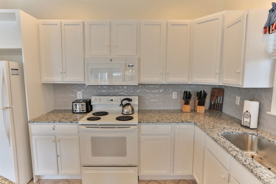 NEW in 2020- Refinished cabinets, granite countertop, tile backsplash and floor.