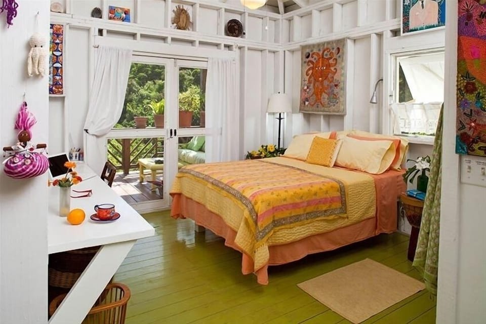 The romantic bedroom opens onto the oversized covered porch.