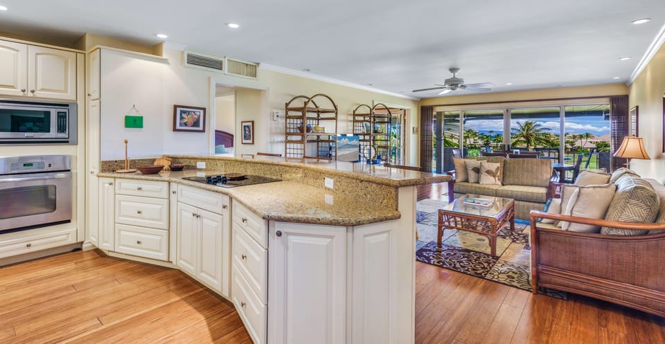Cooking island has open view onto living room and dining area.