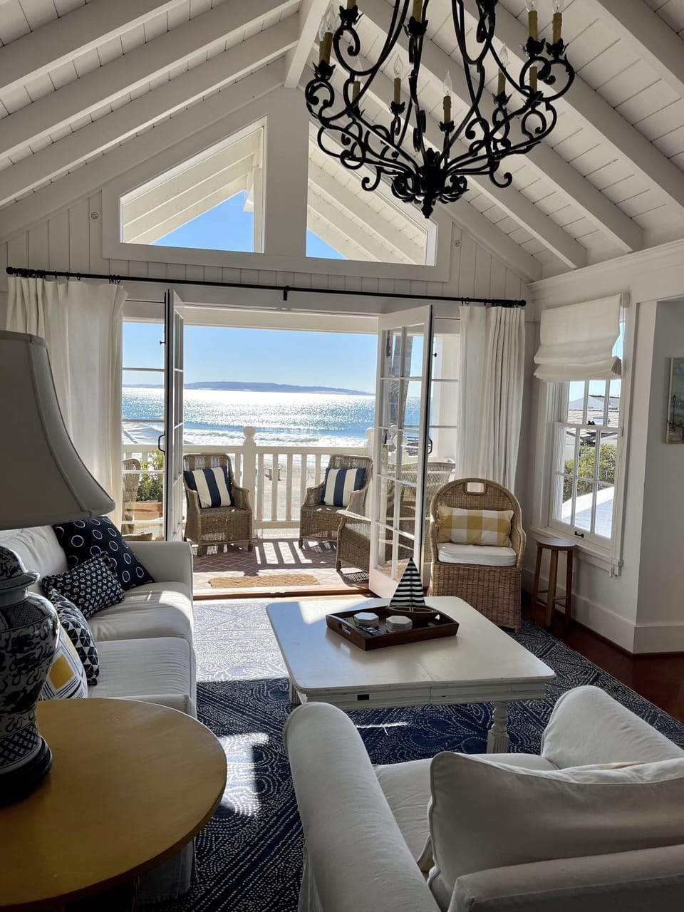 French doors invite indoor/outdoor living. A balcony overlooks the boardwalk.