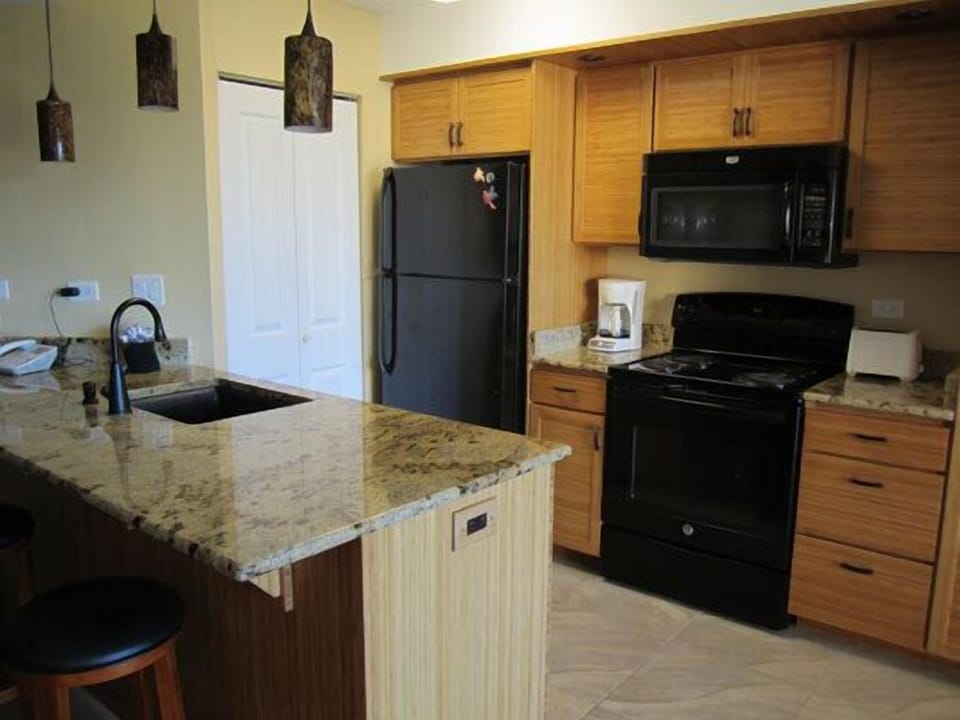 Remodeled kitchen with new cabinets, appliances, and granite counters 