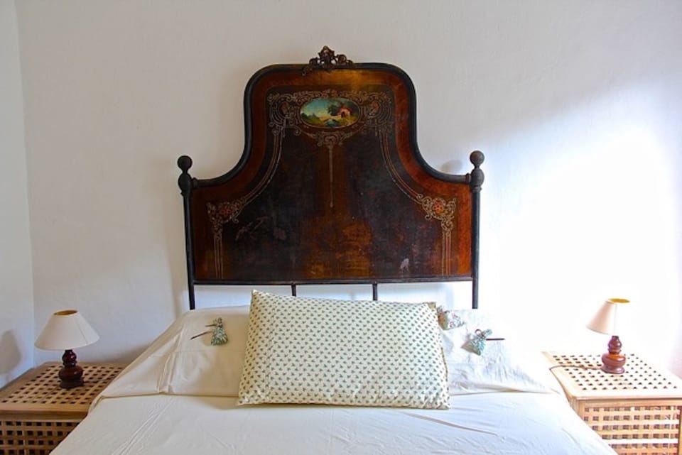 The bedroom has an antique Italian bed, but with a comfortable modern mattress