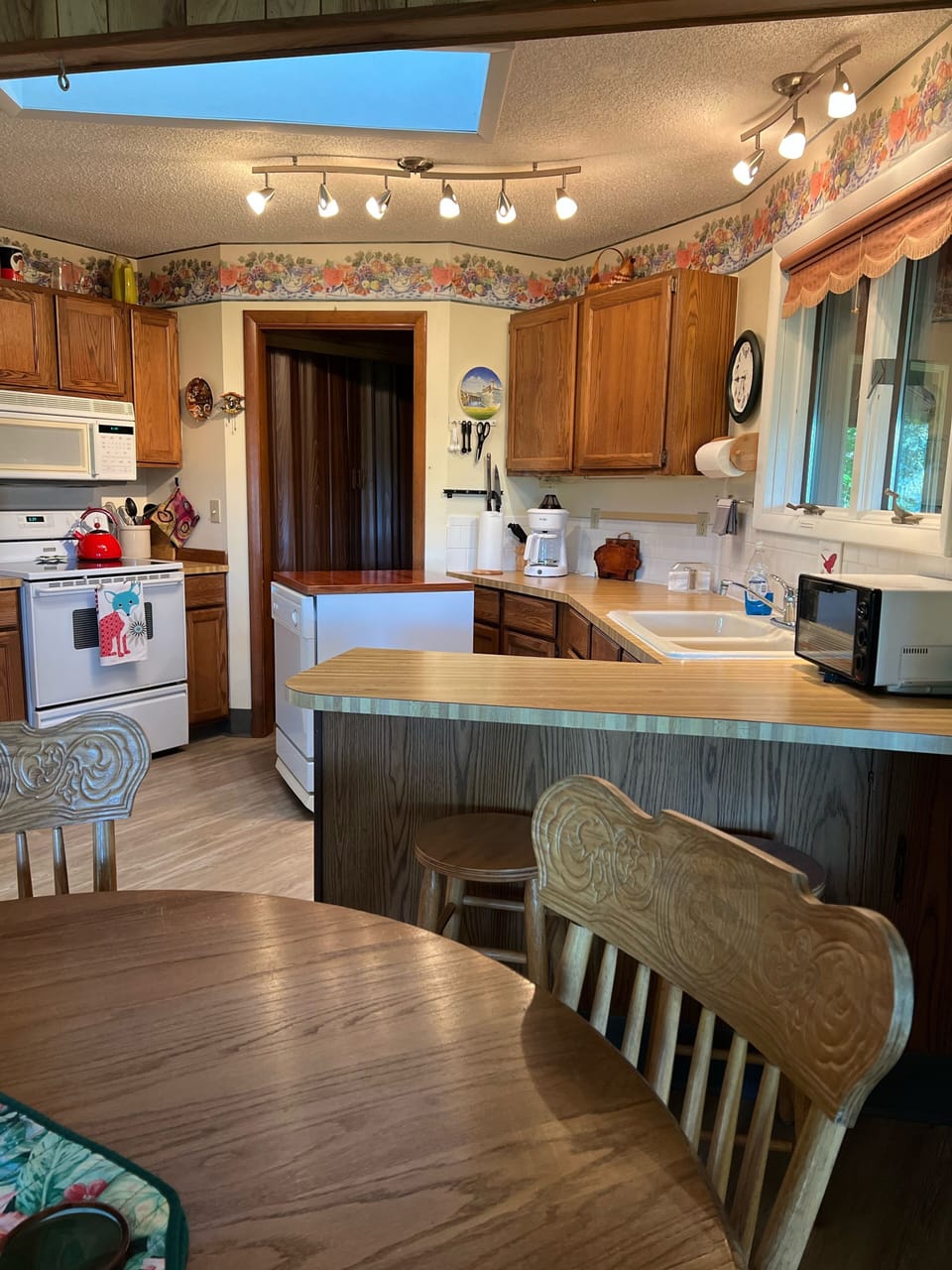 Complete kitchen includes coffee maker, grinder, toaster, dishwasher, microwave.