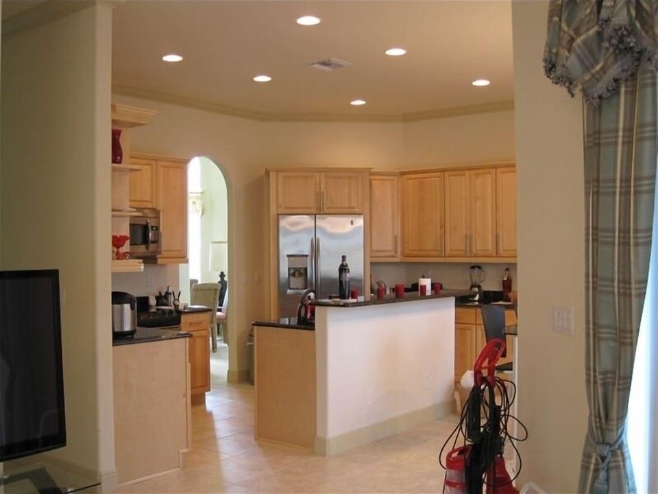 view of kitchen from family room.
formal dining is just visible through arch.