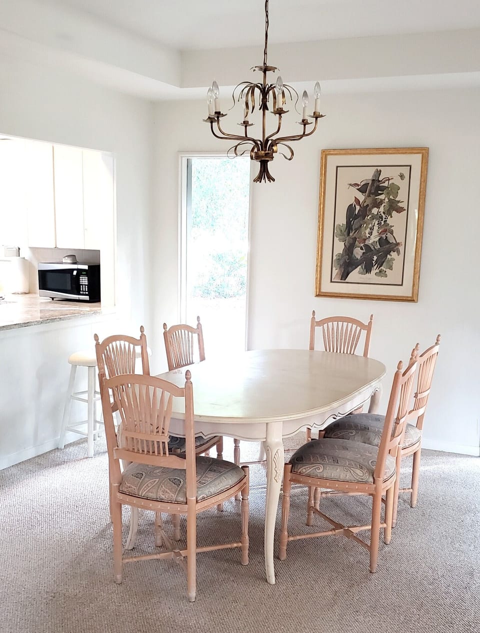 Dining room with kitchen on the left side.