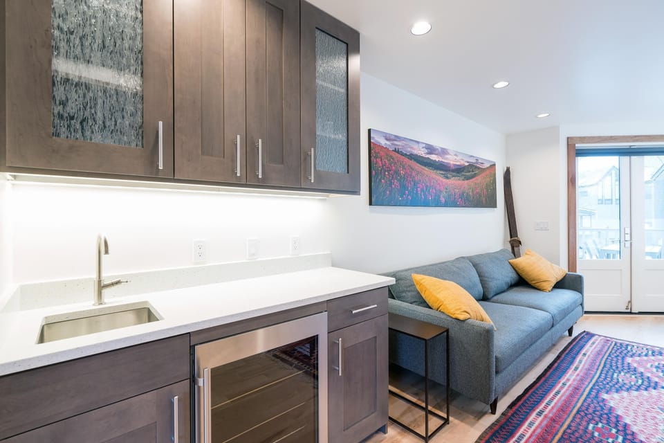 Living room features 4-seater sofa & 43" LCD TV adjacent to coffee & bar area