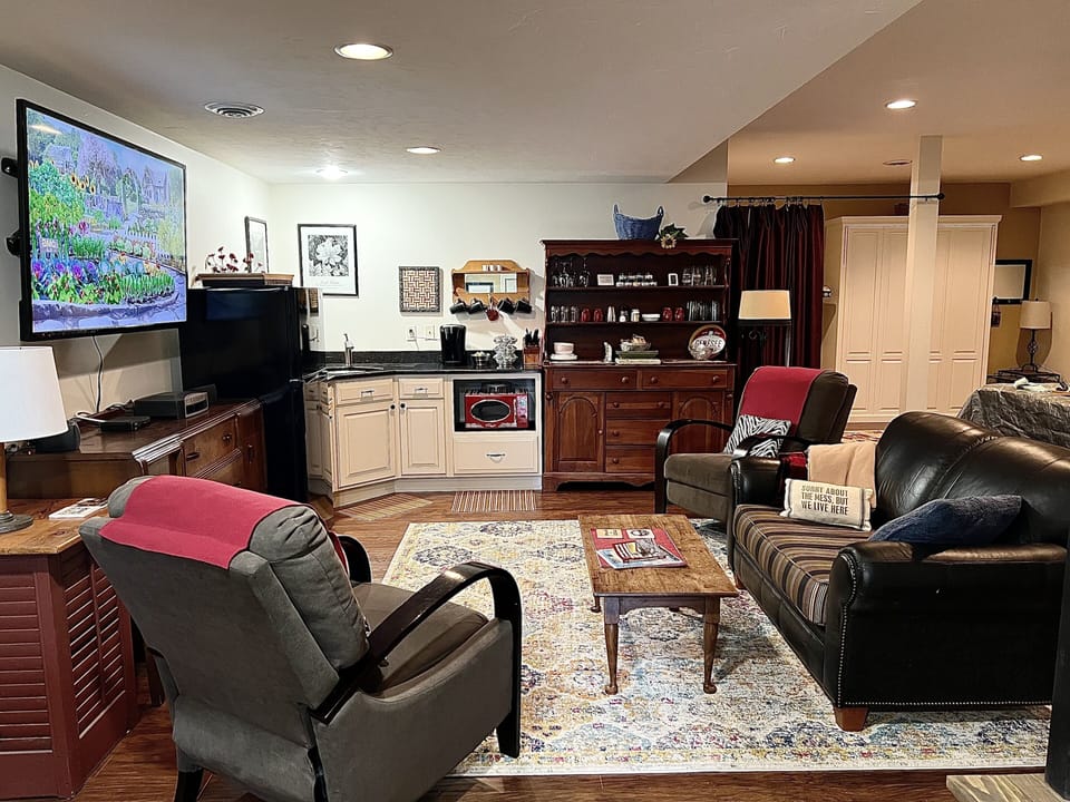 Photo of the lounge area and kitchenette. The kitchen does not have a stove. 