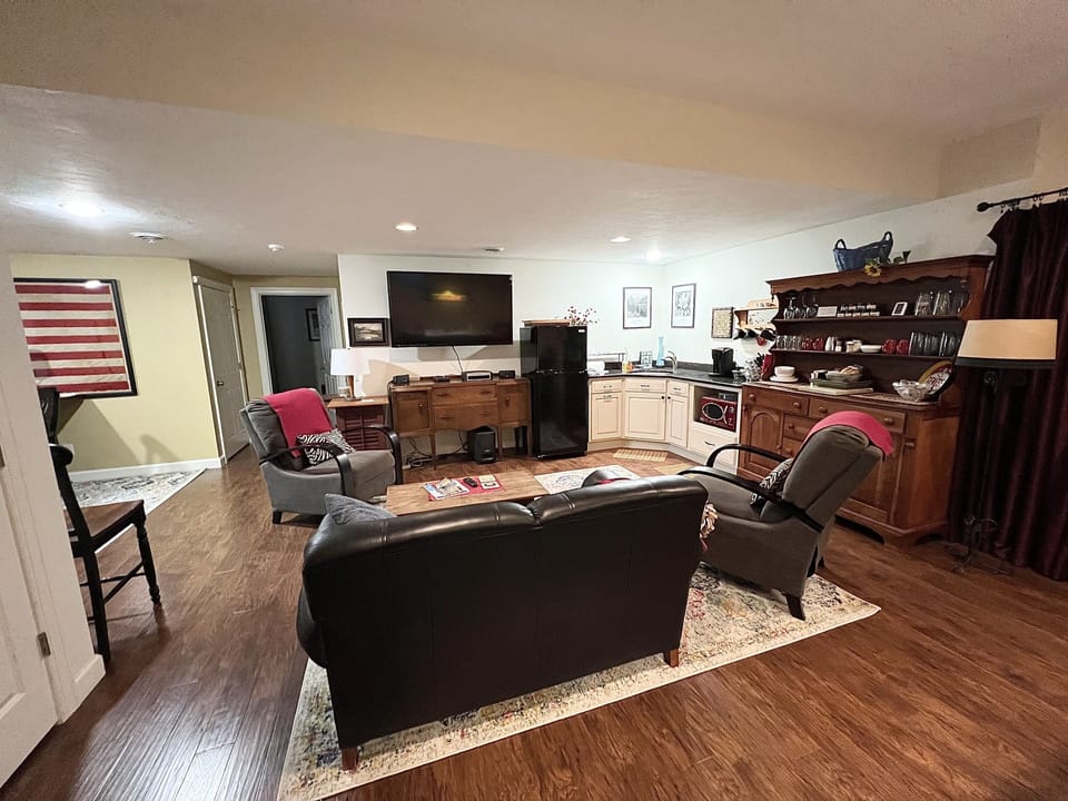 Another view from the pool table of the lounge area which includes 2 recliners.