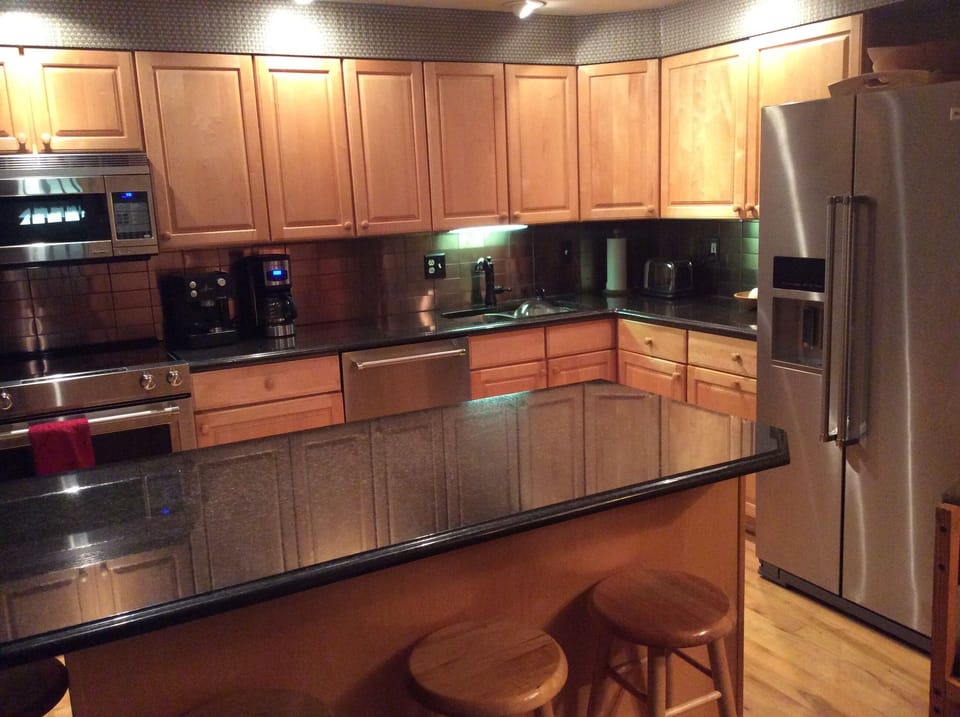 New appliances and countertops in fully-equipped kitchen 
