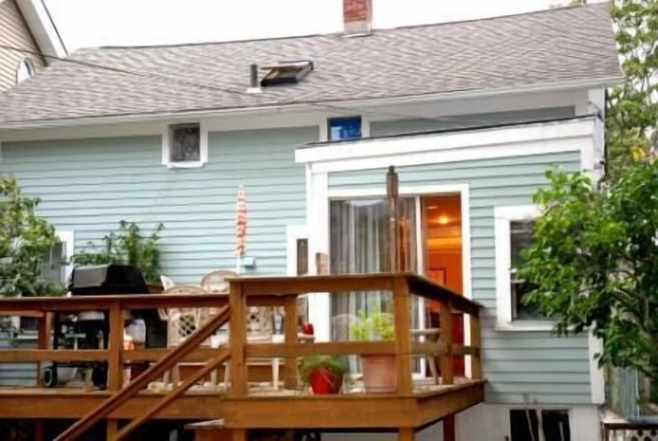 REAR DECK OFF KITHCEN WITH TABLE AND GRILL