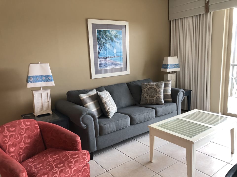Relax in our spacious living room featuring balcony access and a flat screen TV!
