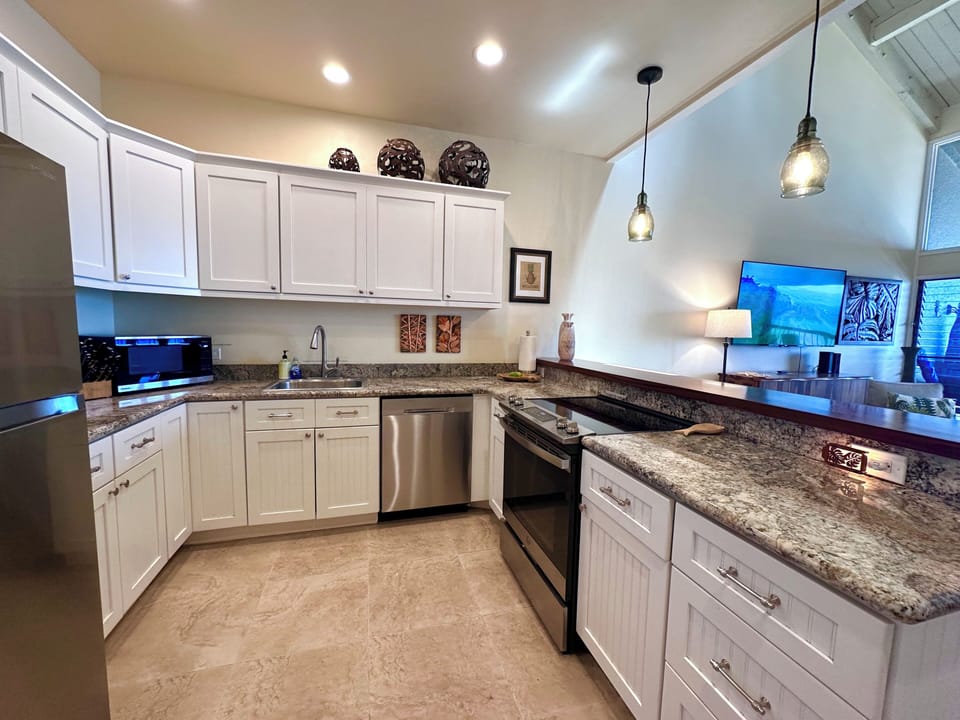 Fully stocked kitchen with modern appliances.